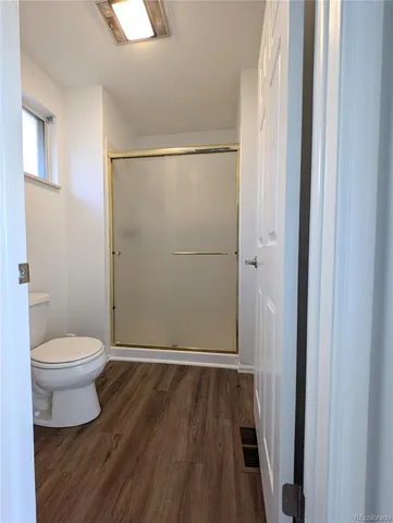 a bathroom with a toilet and a shower