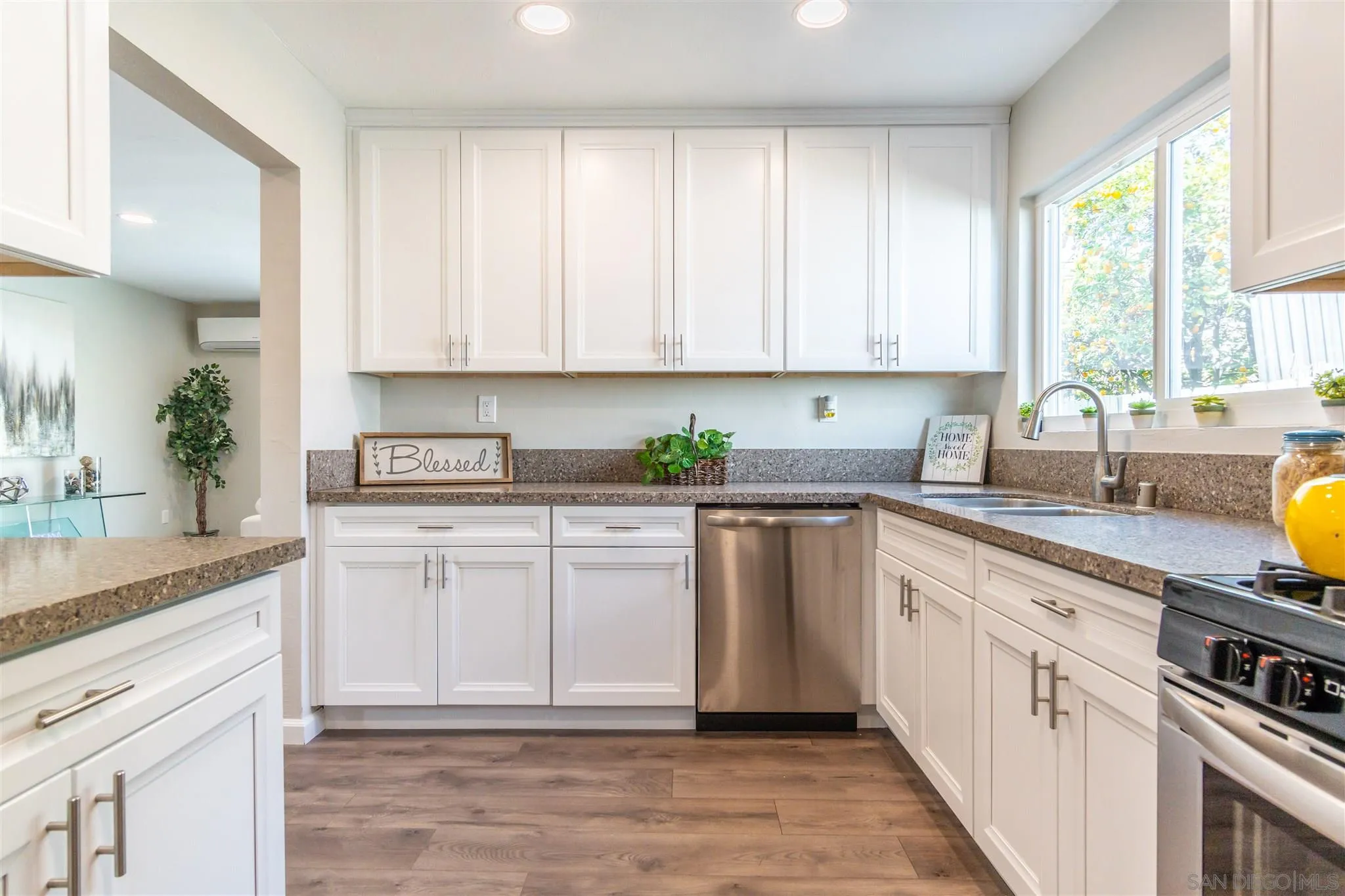 466 Cedar Street El Cajon, CA 92021 - Photo 11 of 26 a kitchen with a white cabinets sink and window