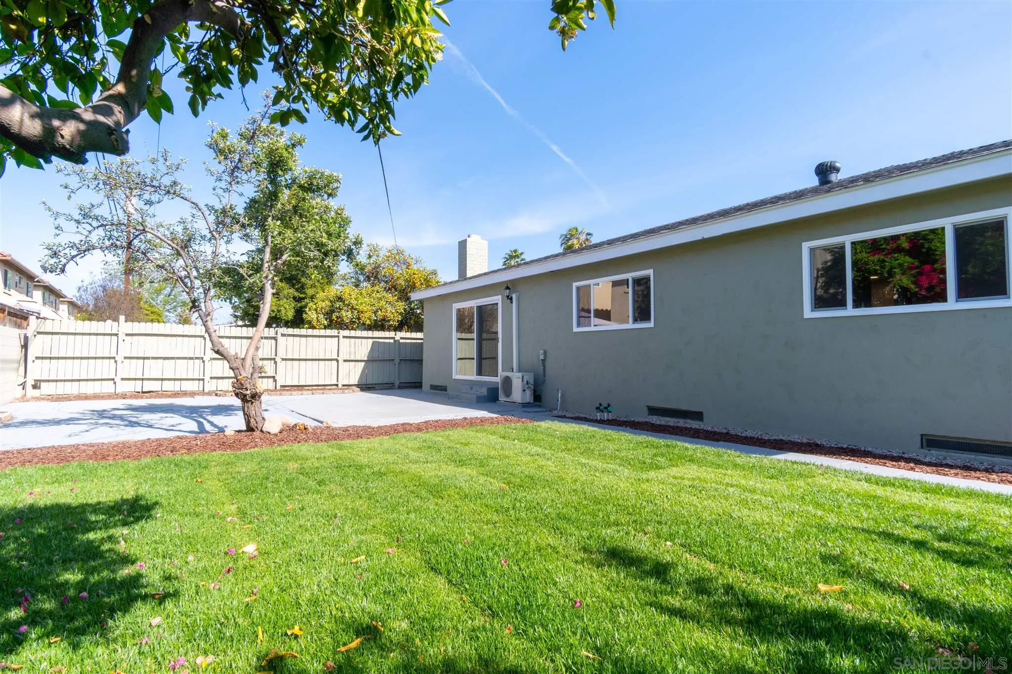 466 Cedar Street El Cajon, CA 92021 - Photo 24 of 26 a view of back yard of a house with deck and a garden