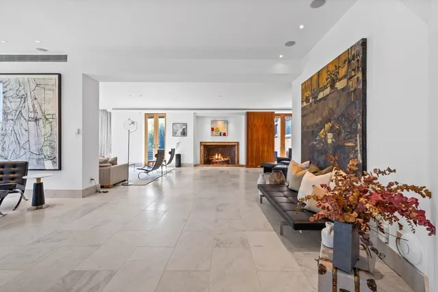 a living room with furniture and a floor to ceiling window