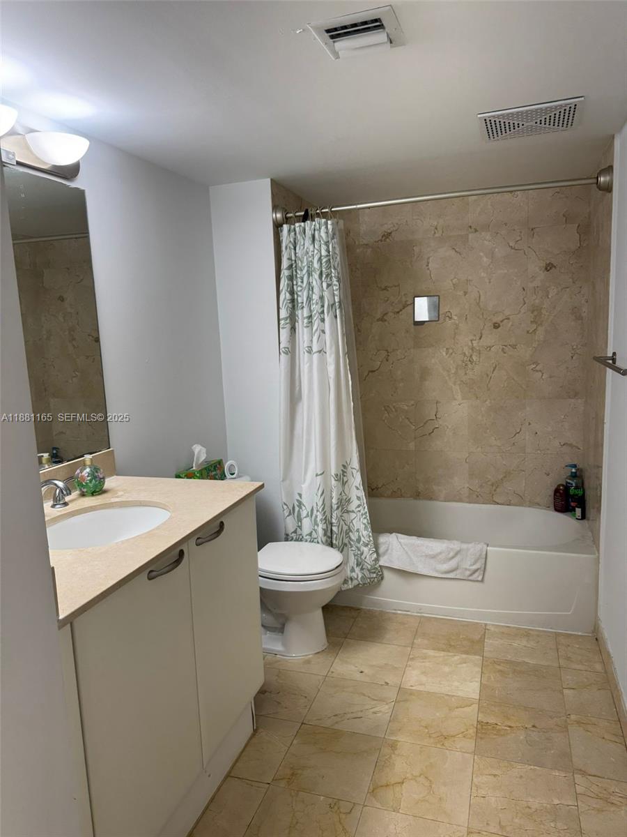 2101 Brickell Avenue, Unit 308 Miami, FL 33129 - Photo 12 of 19 a bathroom with a sink a toilet and tub