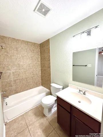 a bathroom with a sink a toilet and bathtub