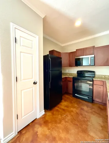 a kitchen with stainless steel appliances a refrigerator and a stove