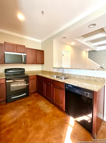 a kitchen with stainless steel appliances granite countertop a sink and a stove