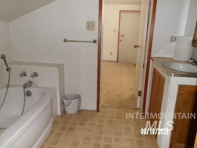 31997 2nd Fork Road Ola, ID 83657 - Photo 23 of 47 Pedestal sink with integrated countertop, wood-finish vanity, and tiled flooring