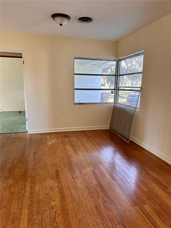 2800 Southland Road Mount Dora, FL 32757 - Photo 6 of 11 wooden floor in an empty room with a window