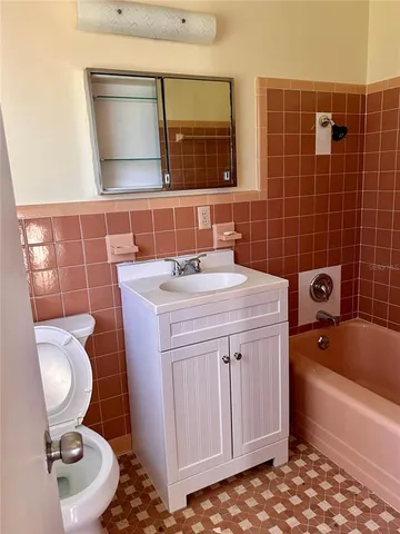 a bathroom with a sink a toilet and bathtub