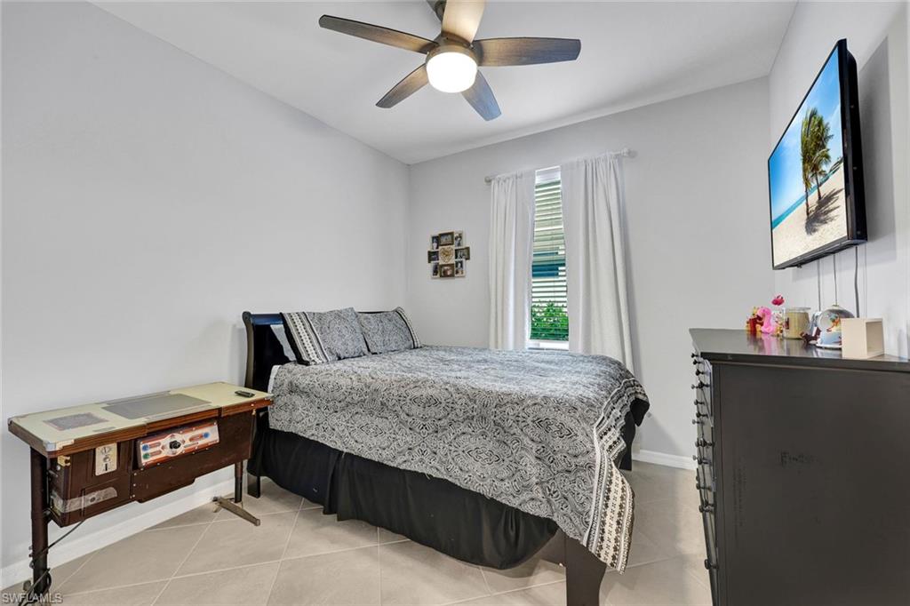 2622 Scarlet Way Naples, FL 34120 - Photo 11 of 24 a bedroom with a bed and a chandelier