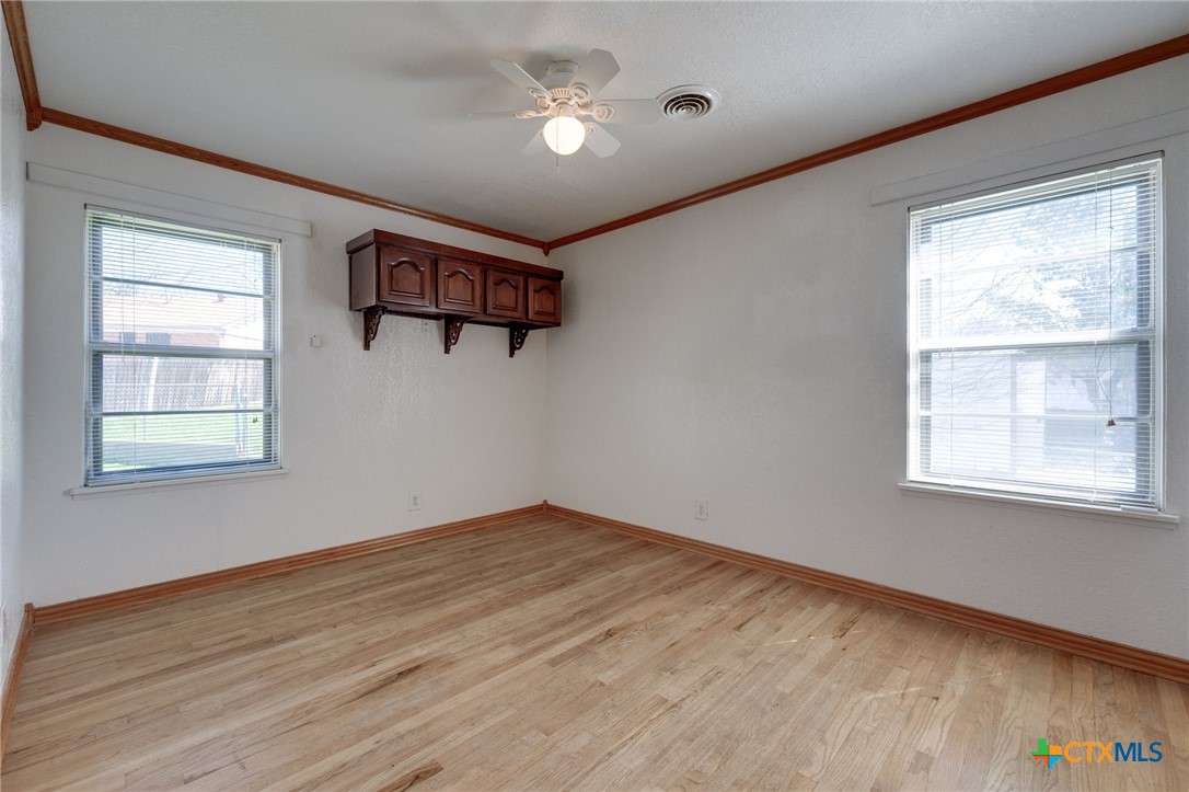 416 Cardinal Avenue Killeen, TX 76541 - Photo 5 of 18 a view of an empty room with a window and wooden floor