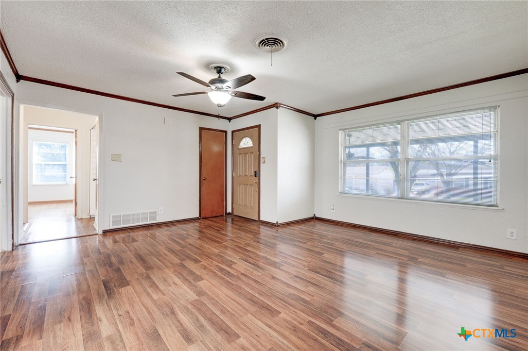 416 Cardinal Avenue Killeen, TX 76541 - Photo 8 of 18 a view of an empty room with a window and wooden floor