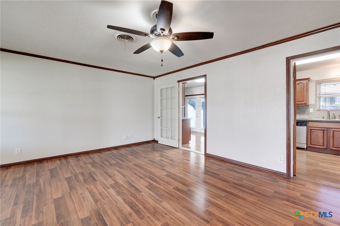 416 Cardinal Avenue Killeen, TX 76541 - Photo 10 of 18 a view of an empty room with wooden floor and a ceiling fan