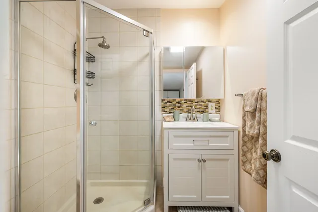 a bathroom with a shower and a sink