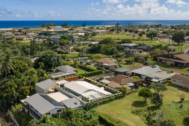 an aerial view of residential houses with outdoor space