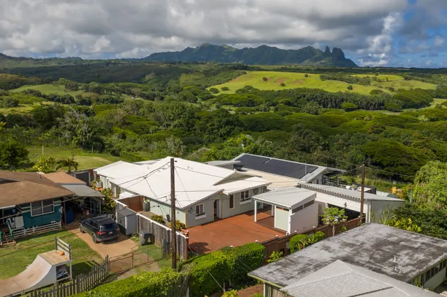 a view of a patio with a table and chairs under an umbrella