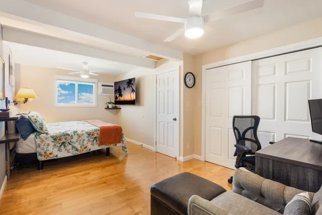 a bedroom with furniture and a window