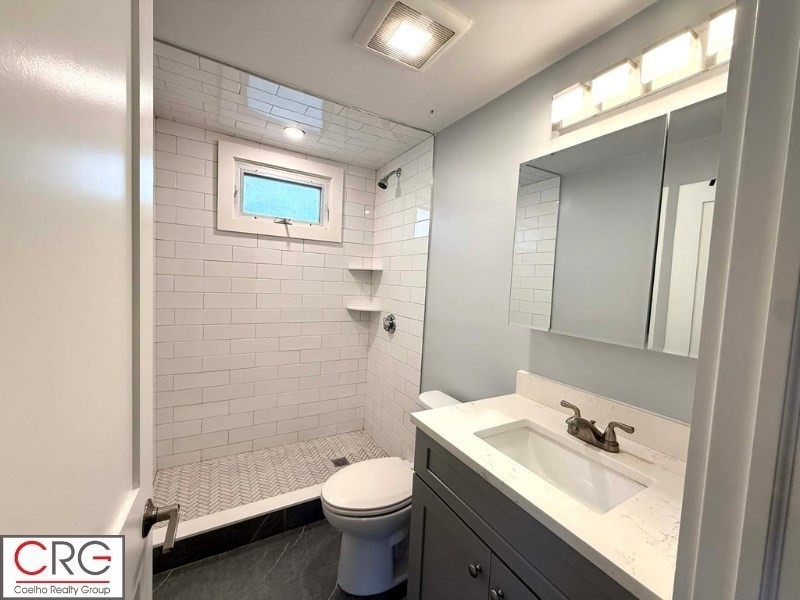 45 North Emerson Street, Unit 1 Wakefield, MA 01880 - Photo 6 of 12 a bathroom with a sink a toilet and shower