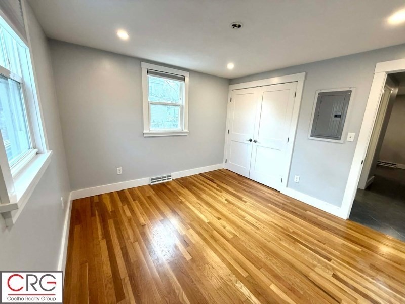 45 North Emerson Street, Unit 1 Wakefield, MA 01880 - Photo 9 of 12 a view of a room with wooden floor and bedroom