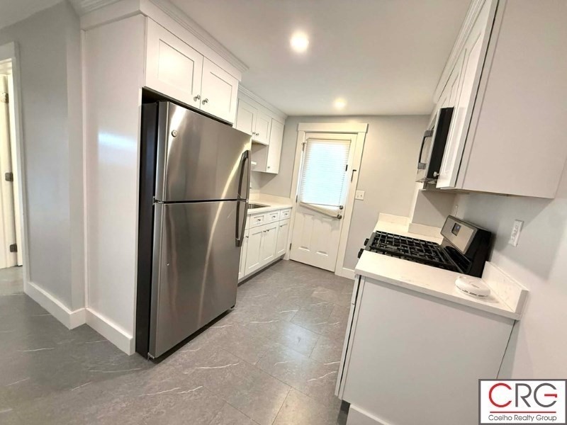 45 North Emerson Street, Unit 1 Wakefield, MA 01880 - Photo 10 of 12 a view of a kitchen with a sink refrigerator and window