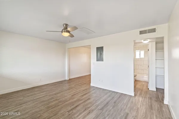 wooden floor in an empty room with a window