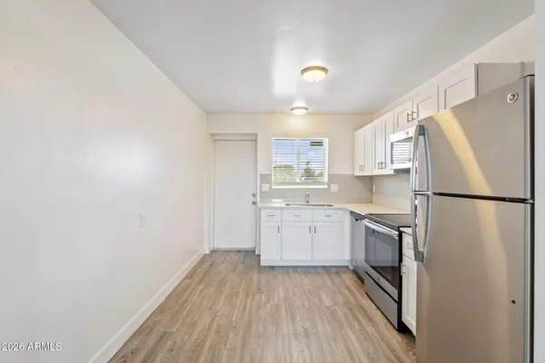 a kitchen with a refrigerator a sink and dishwasher