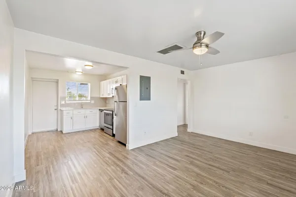 a view of a kitchen with wooden floor and a kitchen