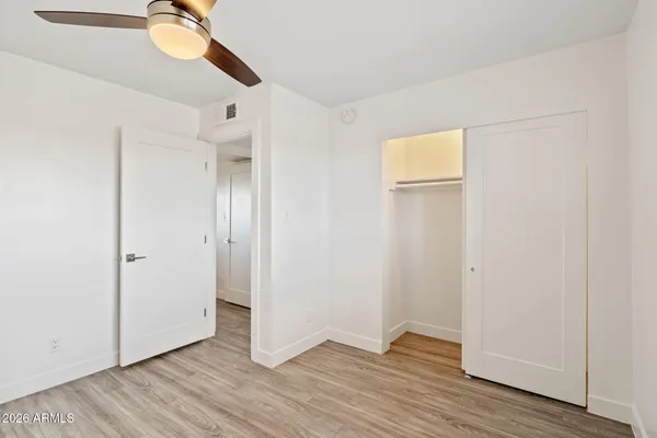 a view of an empty room with wooden floor