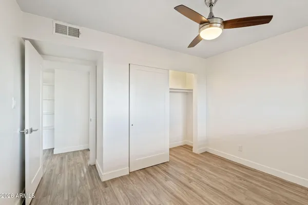 a view of empty room with wooden floor