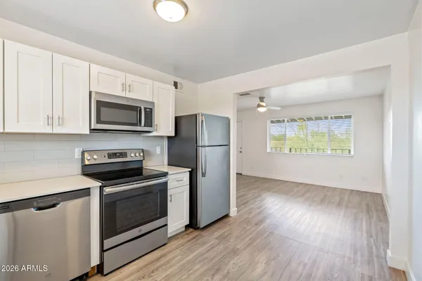 a kitchen with stainless steel appliances a refrigerator stove microwave and sink