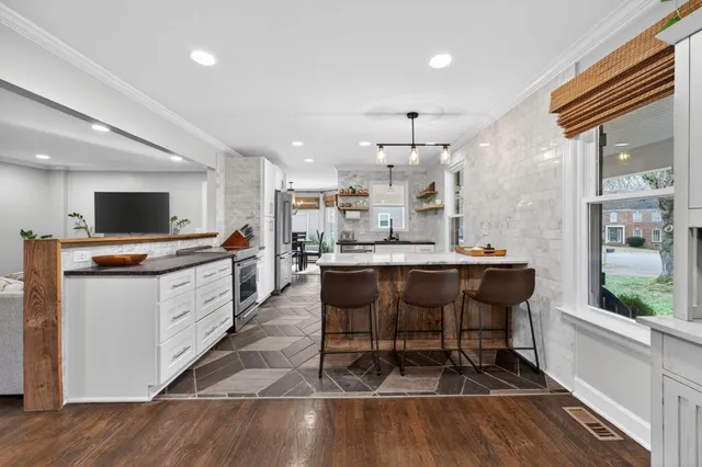 a kitchen with granite countertop a stove and a sink