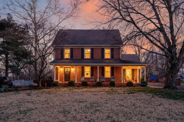 a view of a patio with table and chairs under an umbrella