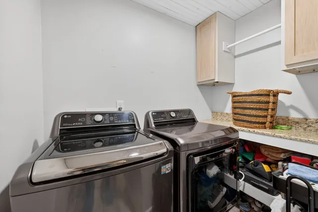a bedroom with a bed a painting on the wall and a window
