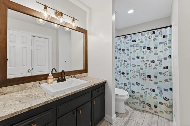 a large bed sitting in a bedroom next to a window