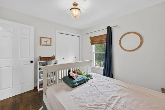 a vase of flowers sitting on a table with window