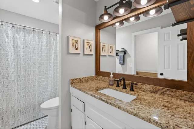 an aerial view of a house with a garden and lake view