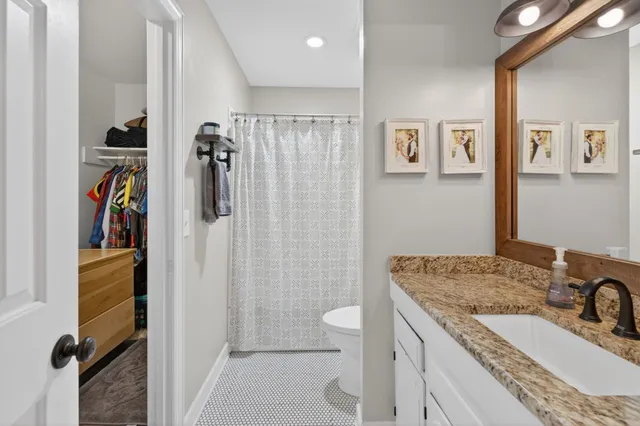 an aerial view of a house with a yard and lake view