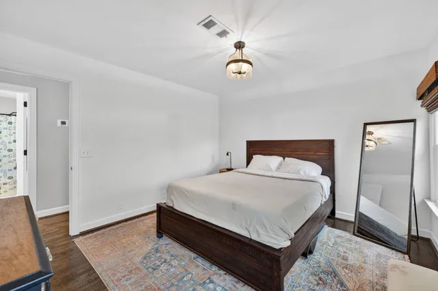 a view of a tennis ground with large trees