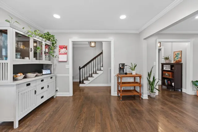 a kitchen with a table chairs microwave and cabinets