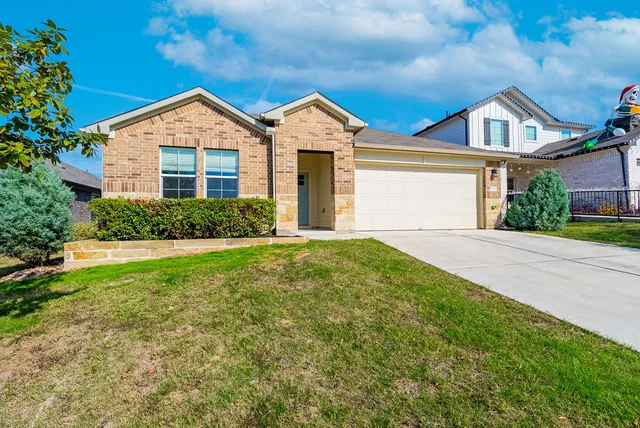 front view of a house next to a yard