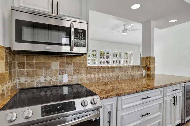 a stove top oven sitting inside of a kitchen