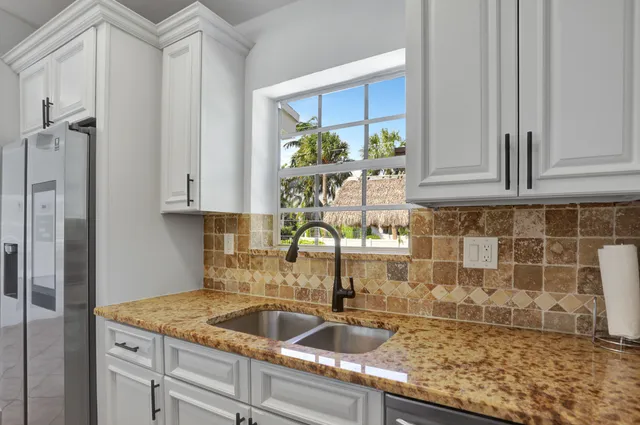 a kitchen with a sink and cabinets