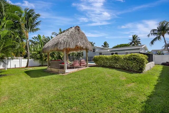 a view of a backyard with sitting area