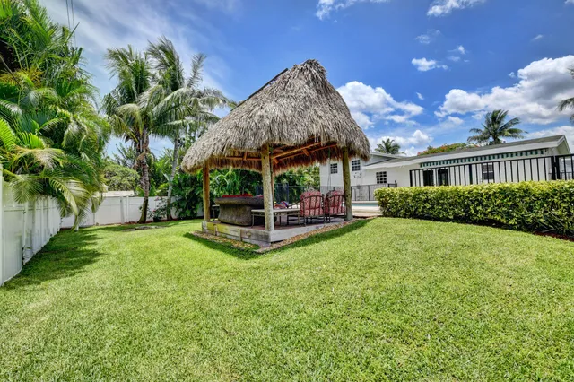 a view of a livingroom with wooden furniture and a ceiling fan
