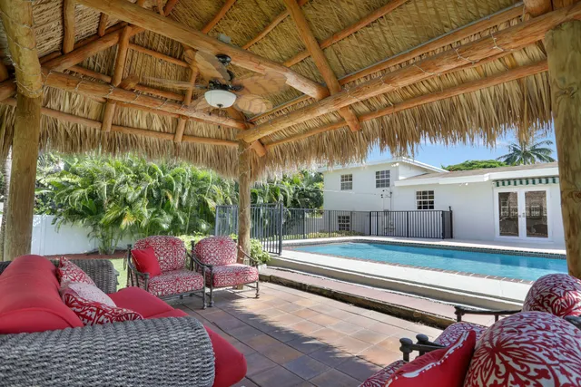 a backyard of a house with barbeque oven table and chairs