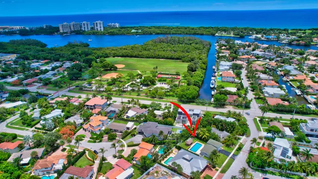 an aerial view of residential houses with outdoor space and trees