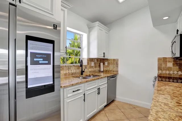 a kitchen with stainless steel appliances granite countertop a sink and cabinets