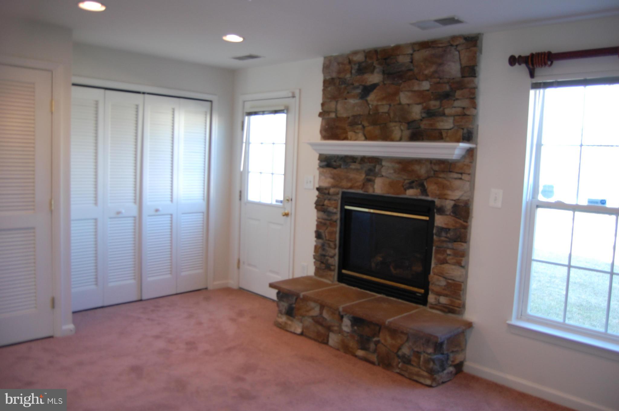 7636 Fairbrook Road Baltimore, MD 21244 - Photo 5 of 19 Brick fireplace in lower level family room