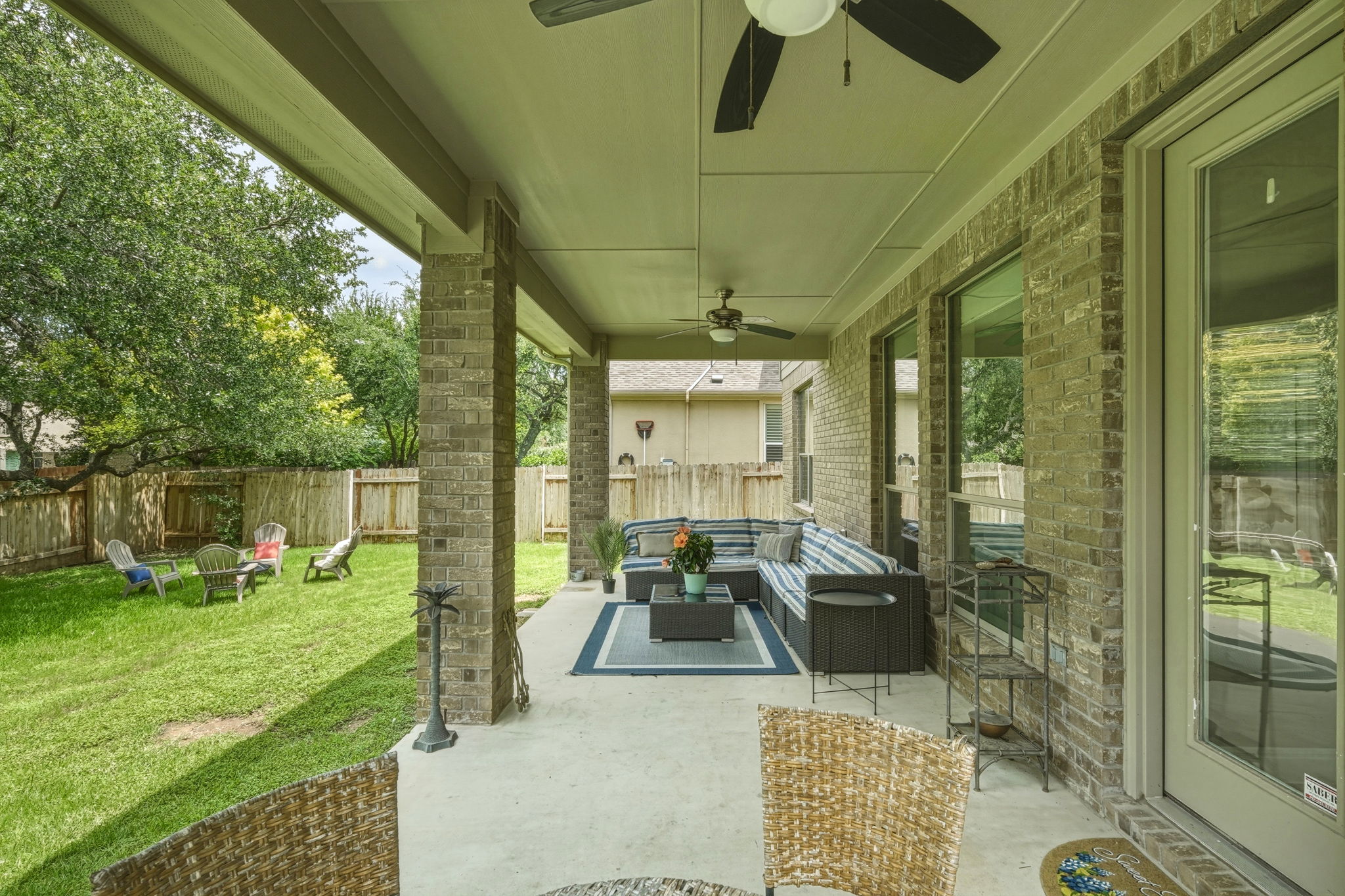 110 Dasher Drive Cedar Park, TX 78613 - Photo 19 of 39 An inviting covered patio with ceiling fans offers a perfect outdoor living space.