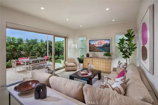 a living room with furniture and a potted plant