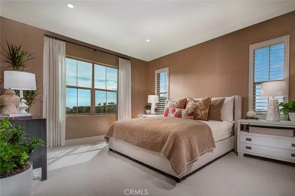 a bed room with a bed and a potted plant