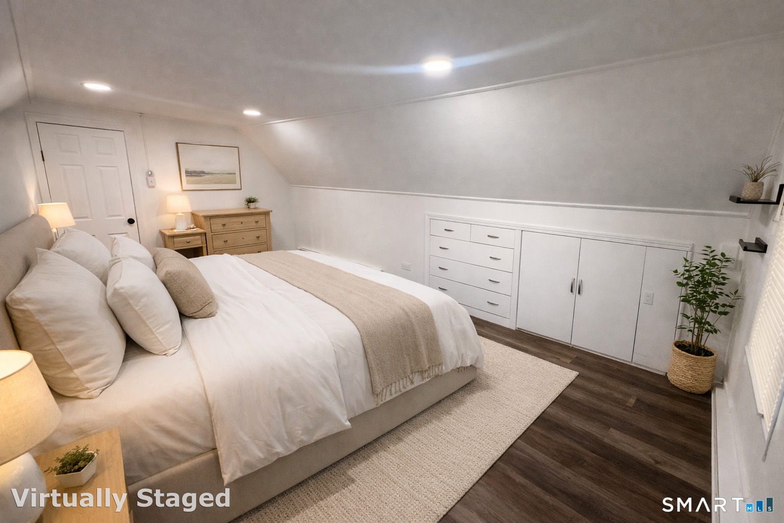 a large white bed in a white room